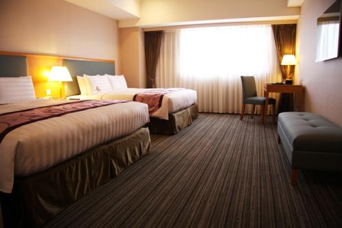 Postel nebo postele na pokoji v ubytování Fushin Hotel - Tainan