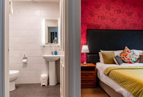 a bedroom with a bed and a sink and a toilet at Foley's Guesthouse & Self Catering Holiday Homes in Kenmare