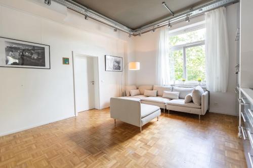 a living room with a couch and a table at Green Residence Boutique Lofts & Villa in Offenbach