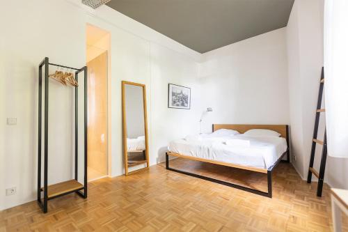 a bedroom with a bed and a mirror at Green Residence Boutique Lofts & Villa am Park in Offenbach