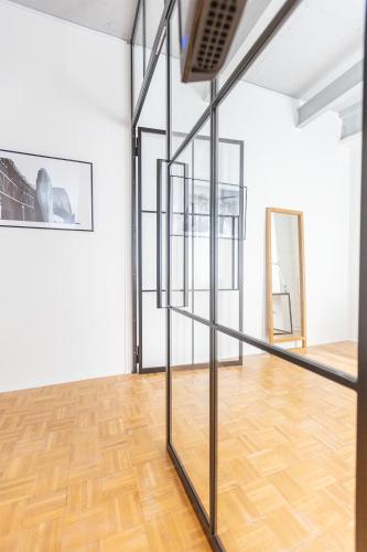 a room with a glass staircase in a room with a wooden floor at Green Residence Boutique Lofts & Villa am Park in Offenbach