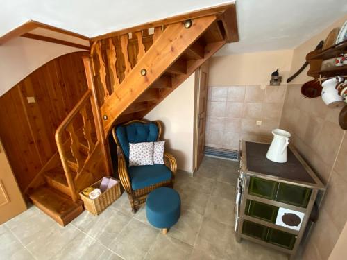 a room with a staircase with a chair and a table at Chata Čeladná in Čeladná