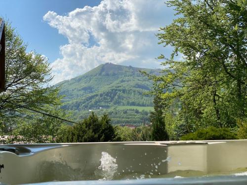a bath tub with a view of a mountain at Chata Čeladná in Čeladná