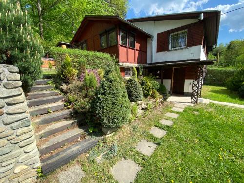 a house with a staircase leading to a yard at Chata Čeladná in Čeladná