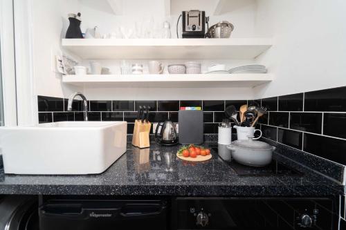 a kitchen with a sink and a counter top at Tiddles in St Ives