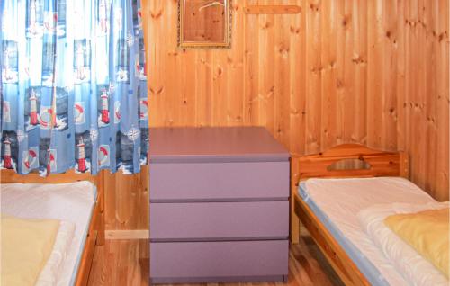 a bedroom with a desk and two beds in it at Awesome Home In Spangereid With Kitchen in Korshamn