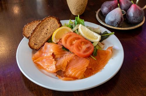 a plate of food with salmon and bread on a table at Foley's Guesthouse & Self Catering Holiday Homes in Kenmare