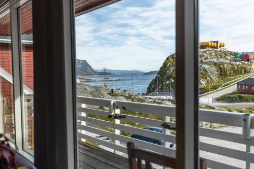 a window view of the ocean from a house at HOTEL SØMA Nuuk in Nuuk