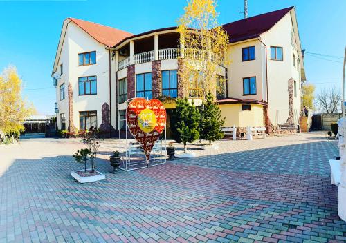 a large building with two red signs in front of it at Pid Yavorom in Ivano-Frankivsʼk