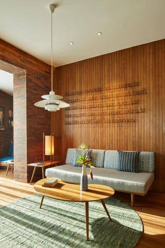 a living room with a couch and a table at Potato Head Suites & Studios in Seminyak