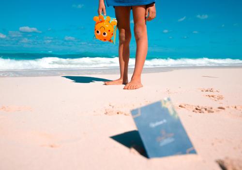 a woman standing in the sand on the beach at Retal View North Coast Aqua Park in El Alamein