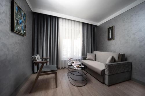 a living room with a couch and a table at The Wings Hotels Neva Palas in Ankara