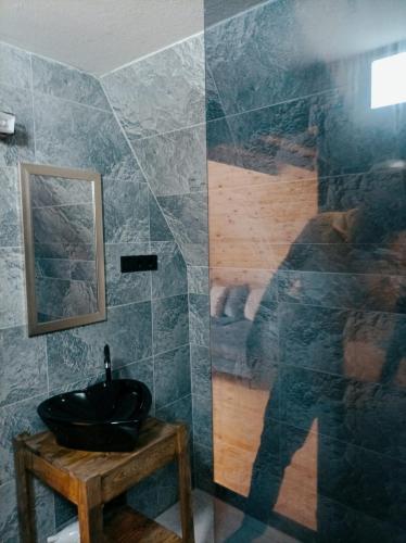 a bathroom with a black sink and a mirror at Çınarhan Villas in Agva