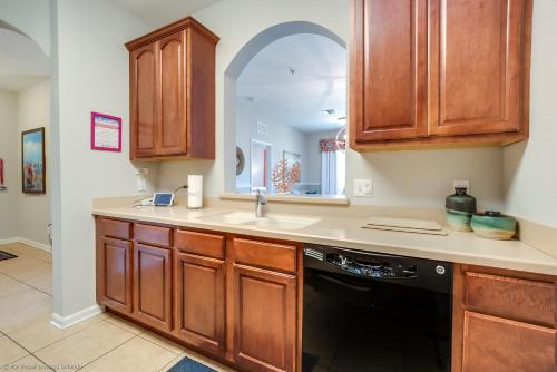 a kitchen with a sink and a dishwasher at Spacious Vista Cay Condo, near Resort Pool in Orlando