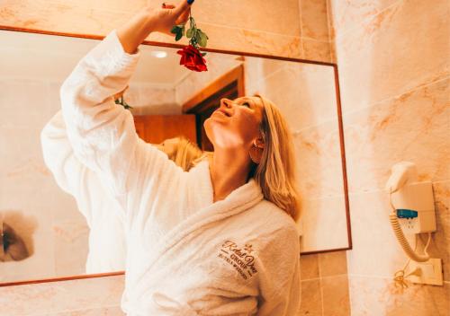 a woman brushing her hair in front of a mirror at Retal View North Coast Aqua Park in El Alamein