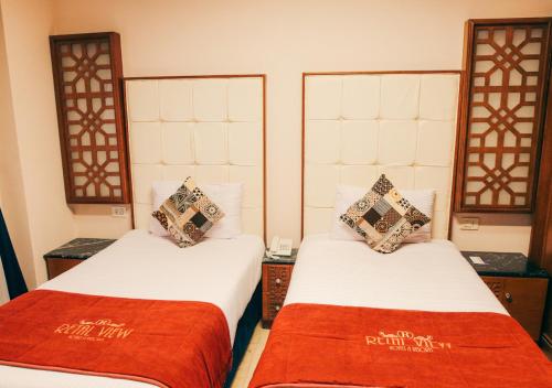 a room with two beds with red blankets at Retal View North Coast Aqua Park in El Alamein
