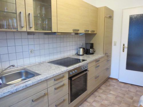a kitchen with a sink and a stove top oven at Ferienwohnung Birkenflair in Seebruck