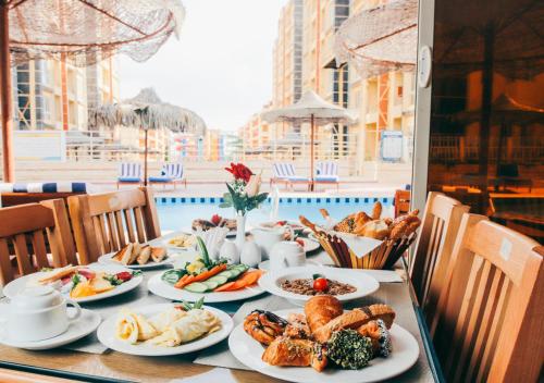 a table with plates of food on top of it at Retal View North Coast Aqua Park in El Alamein