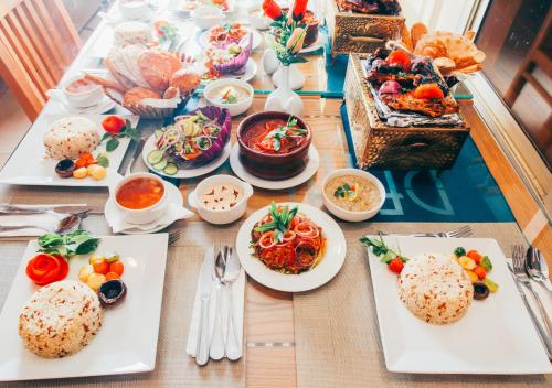 a table with plates of food on top at Retal View North Coast Aqua Park in El Alamein