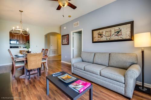 a living room with a couch and a table at Beautiful PET FRIENDLY Condo Near Pool in Orlando