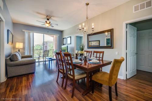 a dining room and living room with a table and chairs at Beautiful PET FRIENDLY Condo Near Pool in Orlando