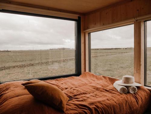 ein Schlafzimmer mit einem Bett mit Hut darauf in der Unterkunft Parcel Tiny House I Chèvrerie de Rilly in Cravant