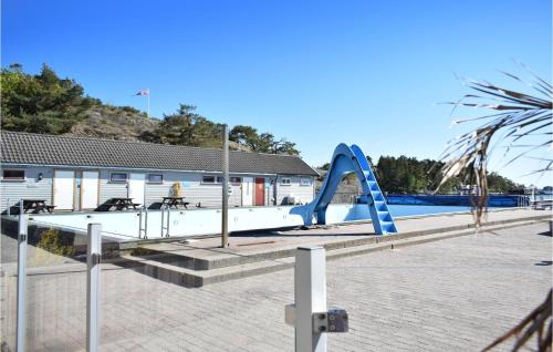 a playground with a slide in front of a building at Stunning Home In Søgne in Søgne