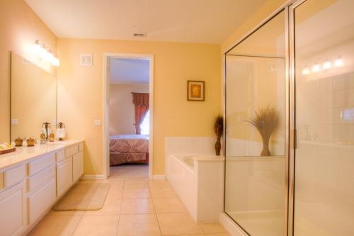 a bathroom with a shower and a sink and a tub at Lovely Third-Floor Vista Cay Resort Condo in Orlando