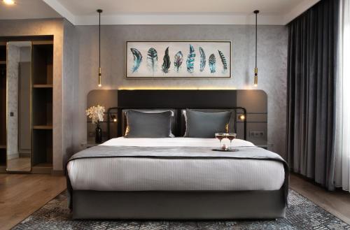 a bedroom with a large bed with a black headboard at The Wings Hotels Neva Palas in Ankara