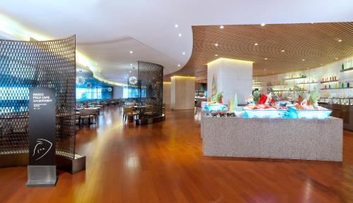 a hotel lobby with a bar and a restaurant at Wingtech Hotel in Huangshi
