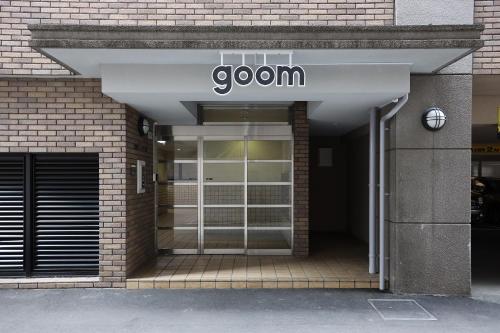 a door to a building with a sign on it at goom Hotel Fukuoka-Tenjin in Fukuoka
