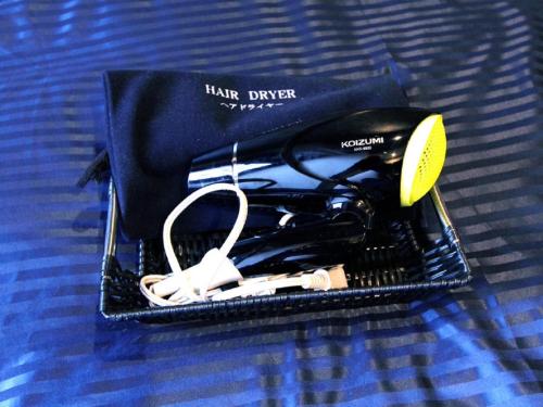 a black bag with a pair of controllers in it at HOTEL LiVEMAX Chiba Soga-Ekimae in Chiba