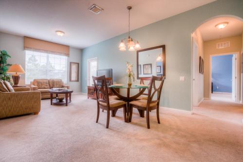 a dining room and living room with a table and chairs at Vista Cay Condo w FREE Resort Access, near Disney in Orlando