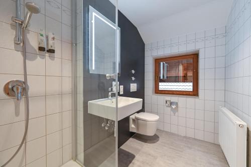 a bathroom with a toilet and a sink and a shower at Helmerhof in Schwangau