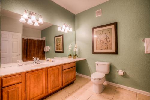 a bathroom with a sink and a toilet in it at Vista Cay Condo w FREE Resort Access, near Disney in Orlando