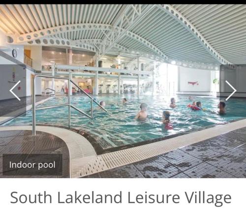 a group of people swimming in a swimming pool at Dot's Place 1 in Carnforth