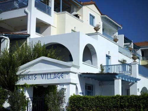 a white building with the words knights villas on it at Nikis Village in Poros