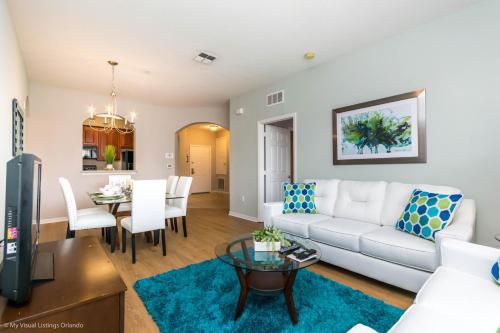 a living room with a white couch and a table at Spacious Condo Near Convention Ctr & I-Drive, Pool in Orlando