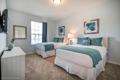 a bedroom with two beds and a window at Spacious Condo Near Convention Ctr & I-Drive, Pool in Orlando