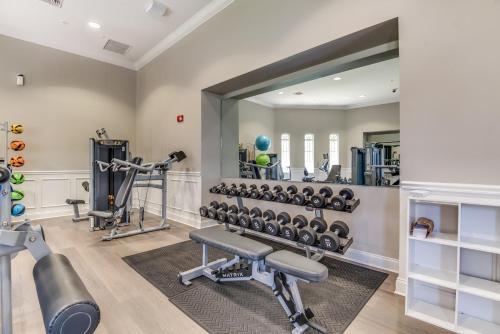 a fitness room with a large mirror and a gym at Stylish Condo at Vista Cay Resort Minutes to WDW in Orlando