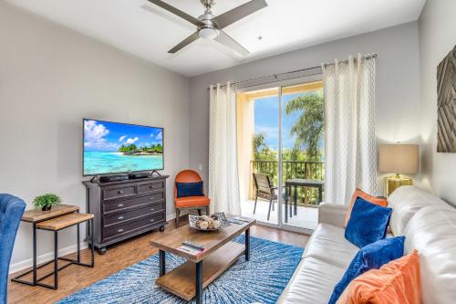a living room with a couch and a tv at Newly Updated Condo w Scenic Resort View in Orlando