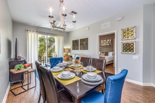 a dining room and living room with a table and chairs at Newly Updated Condo w Scenic Resort View in Orlando