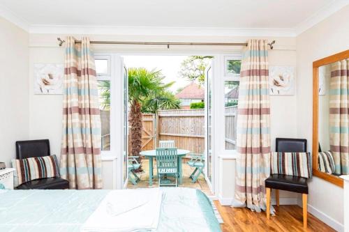 - une chambre avec un lit, une table et des chaises dans l'établissement BOURNECOAST: LOVELY ANNEX WITH PATIO NR BEACH-5286, à Bournemouth