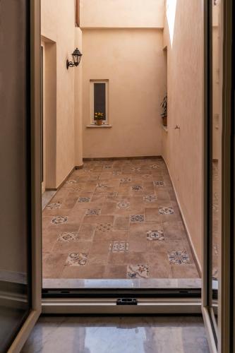 an empty corridor with a tile floor in a hallway at Al Duomo B&B in Amantea