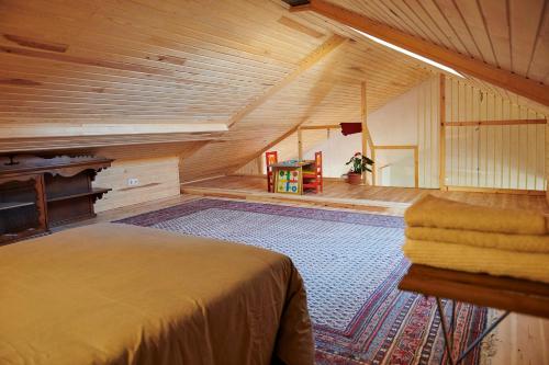 a large attic room with a bed and a rug at Casa Urbión-Pinares de Soria in Covaleda