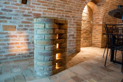 a brick wall with a fireplace in a room at Ecitlav - ubytování Valtice in Valtice