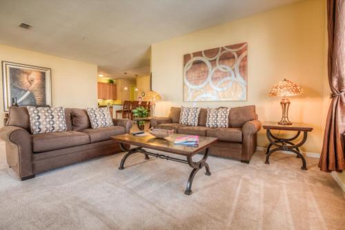 a living room with two couches and a coffee table at Luxurious Condo wPrivate Balcony AMAZING View in Orlando