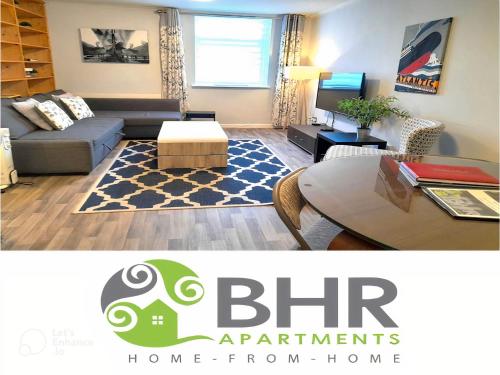 a living room with a couch and a table at Excellent Location - City Centre - Parking - 4 Beds -2 Bedrooms in Belfast