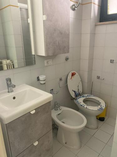 a bathroom with a toilet and a sink at A casa di Nonna Maria in Marcelli