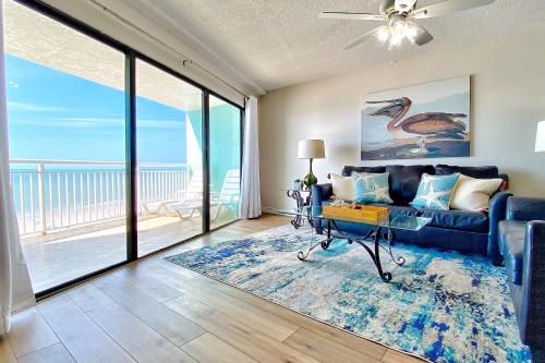 a living room with a couch and a view of the ocean at Chateaux Sunset Suites 408 in Clearwater Beach